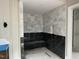 Modern bathroom shower featuring black and white patterned tile walls and a built in bench at 65 Firefly Overlook, Pittsboro, NC 27312