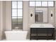 Bright bathroom with a modern vanity and a large window overlooking an outdoor space at 65 Firefly Overlook, Pittsboro, NC 27312