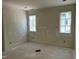 Bright bedroom with two windows ready for finishing touches with fresh drywall and light streaming in at 65 Firefly Overlook, Pittsboro, NC 27312