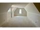 Large bedroom space with vaulted ceilings, ready for finishing touches, showcasing natural light from two windows at 65 Firefly Overlook, Pittsboro, NC 27312