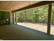 A covered patio with a stone fireplace and sliding glass doors offers seamless indoor-outdoor living with scenic views at 65 Firefly Overlook, Pittsboro, NC 27312