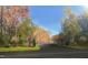 Welcoming community entrance with stone pillars, mature trees, and lush landscaping at 65 Firefly Overlook, Pittsboro, NC 27312