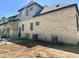 Exterior side view of a brick house with gray siding and three AC units at 65 Firefly Overlook, Pittsboro, NC 27312