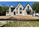 Stunning new construction home featuring a light brick exterior and black trim at 65 Firefly Overlook, Pittsboro, NC 27312