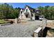 Beautiful new construction home with stone entrance, three-car garage and lots of trees at 65 Firefly Overlook, Pittsboro, NC 27312