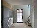 Hallway featuring large arched window and stairwell at 65 Firefly Overlook, Pittsboro, NC 27312