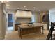 An unfinished kitchen is shown with a large island, ample cabinetry, and a vent hood, offering a customizable culinary space at 65 Firefly Overlook, Pittsboro, NC 27312