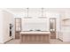 A bright kitchen featuring a large island, modern appliances, and stylish pendant lighting at 65 Firefly Overlook, Pittsboro, NC 27312