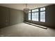 Living room featuring elegant chandelier and large picture windows at 65 Firefly Overlook, Pittsboro, NC 27312