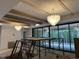 Spacious living room with exposed beam ceiling, modern chandelier, and sliding glass doors at 65 Firefly Overlook, Pittsboro, NC 27312