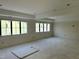 Spacious unfinished living room with recessed lighting and multiple large windows for natural light at 65 Firefly Overlook, Pittsboro, NC 27312