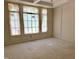 Bright living room featuring custom molding, large window, and neutral color palette under construction at 65 Firefly Overlook, Pittsboro, NC 27312