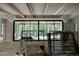 Spacious living room with exposed beam ceiling, modern chandelier, and sliding glass doors at 65 Firefly Overlook, Pittsboro, NC 27312