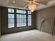 Living room with coffered ceiling, oversized picture window, and elegant light fixture at 65 Firefly Overlook, Pittsboro, NC 27312