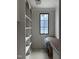 A walk-in pantry with built-in shelving and a window offers ample storage and natural light, enhancing organization at 65 Firefly Overlook, Pittsboro, NC 27312