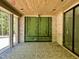 Open covered patio with wood ceiling, brick accent walls and fireplace at 65 Firefly Overlook, Pittsboro, NC 27312