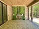 Open patio with brick walls, fireplace and a view of a wooded backyard at 65 Firefly Overlook, Pittsboro, NC 27312