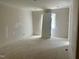 Bright, unfinished bedroom with a door and trim work, ready for customization at 65 Firefly Overlook, Pittsboro, NC 27312