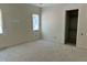 A light-filled room showcases natural light and an open closet during construction at 65 Firefly Overlook, Pittsboro, NC 27312