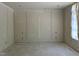 Unfinished room featuring detailed trim work, paneling, and ample natural light from a covered window at 65 Firefly Overlook, Pittsboro, NC 27312