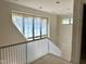 Upstairs staircase with a large window providing lots of natural light and a view at 65 Firefly Overlook, Pittsboro, NC 27312