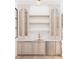 Elegant wet bar featuring marble backsplash, light wood shelves, and wine fridge at 65 Firefly Overlook, Pittsboro, NC 27312