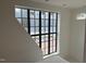 Staircase landing with large black framed grid window, white walls and lots of natural light at 65 Firefly Overlook, Pittsboro, NC 27312