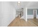 Bright entryway with hardwood floors, white wainscoting, and a staircase at 1440 Old Apex Rd, Cary, NC 27513