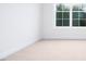 Bright and airy bedroom with a neutral carpet, white trim, and large windows at 1873 Old Fields Blvd, Haw River, NC 27258