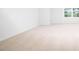Bedroom with tan carpet and a window providing natural light at 1873 Old Fields Blvd, Haw River, NC 27258