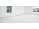 Bright, spacious bedroom features plush carpet and large windows providing natural light and outdoor views at 1873 Old Fields Blvd, Haw River, NC 27258