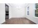Bright dining room with hardwood floors, white trim, a modern chandelier, and large windows at 1873 Old Fields Blvd, Haw River, NC 27258