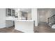 Modern kitchen featuring a white island, stainless steel appliances, and gray cabinets at 1873 Old Fields Blvd, Haw River, NC 27258