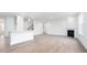 Open living space with a white island, a fireplace, recessed lighting, and hardwood floors at 1873 Old Fields Blvd, Haw River, NC 27258