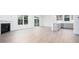 Open living space with a fireplace, hardwood floors, recessed lighting, and a kitchen island at 1873 Old Fields Blvd, Haw River, NC 27258