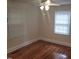 A spacious bedroom with hardwood floors, a ceiling fan, and natural light from two windows at 1202 N Duke St, Durham, NC 27701