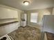 The kitchen offers white cabinets, a stacked washer and dryer, and natural light from a window at 1202 N Duke St, Durham, NC 27701
