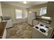 The kitchen has white appliances, including a stacked washer and dryer, and a window with blinds at 1202 N Duke St, Durham, NC 27701