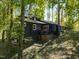 Dark-colored house with deck nestled in a wooded area at 9601 Leslie Dr, Chapel Hill, NC 27516