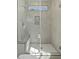 Elegant walk-in shower with gray tiles, bench, seamless glass door and a window at 2337 E Main St, Durham, NC 27703