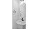 Elegant powder room with modern fixtures, oval mirror, and a pedestal sink at 2337 E Main St, Durham, NC 27703