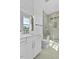 Bright bathroom featuring a modern vanity, shower with glass door and gray tiles at 2337 E Main St, Durham, NC 27703