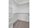 Spacious walk-in closet with built-in shelving and hanging rods, offering ample storage at 2337 E Main St, Durham, NC 27703