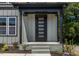 Charming front porch with a black framed glass door and fresh landscaping at 2337 E Main St, Durham, NC 27703