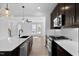 Bright kitchen with stainless steel appliances, dark cabinets and island featuring modern sink fixture at 2337 E Main St, Durham, NC 27703