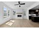 Bright living room features fireplace, ceiling fan, and adjoins modern kitchen at 2337 E Main St, Durham, NC 27703