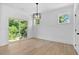 Sun-drenched living room with hardwood floors, large sliding glass door and modern light fixture at 2337 E Main St, Durham, NC 27703