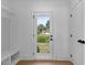Entryway with a bench, storage and door to backyard providing functionality and convenience at 2337 E Main St, Durham, NC 27703