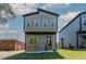 Modern two-story home showcases clean lines, a dark roof, and green siding at 2337 E Main St, Durham, NC 27703