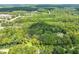 Aerial view showing home on a wooded lot near a lake at 3015 Old Raleigh Rd, Apex, NC 27502